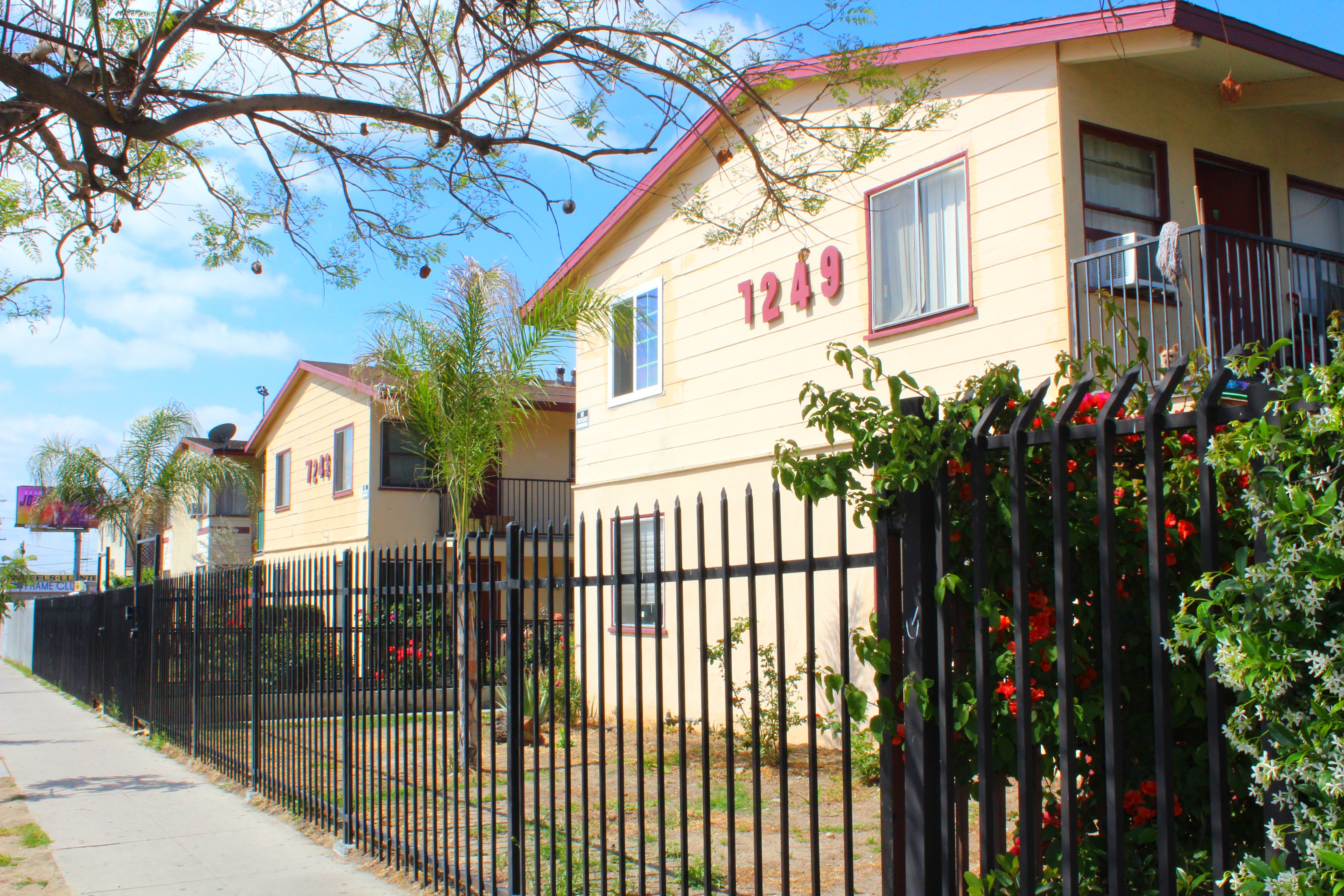A yellow house with the number 1249 on it.